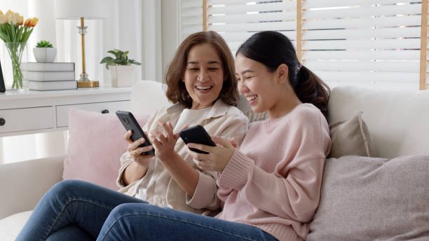 Mom and daughter watching something in mobile phone
