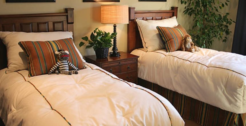 A room with two single beds
